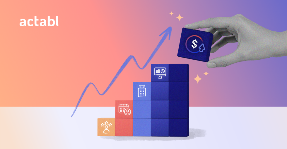 A hand places a block with a dollar sign and arrow on top of a rising stack of blocks with business icons, symbolizing growth, against a gradient background with the word actabl and an upward arrow.