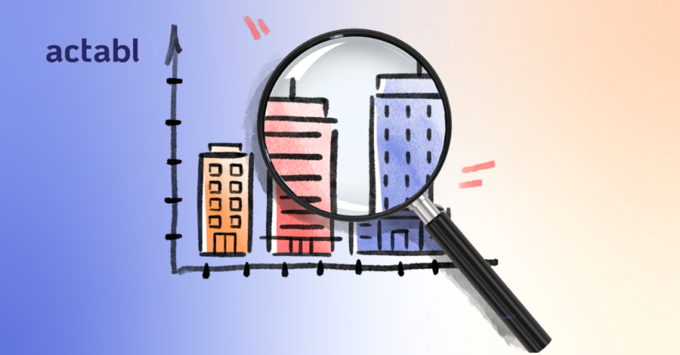 A magnifying glass zooms in on hand-drawn buildings above a bar graph with the partial word actabl on the left. The background fades from blue to light peach.